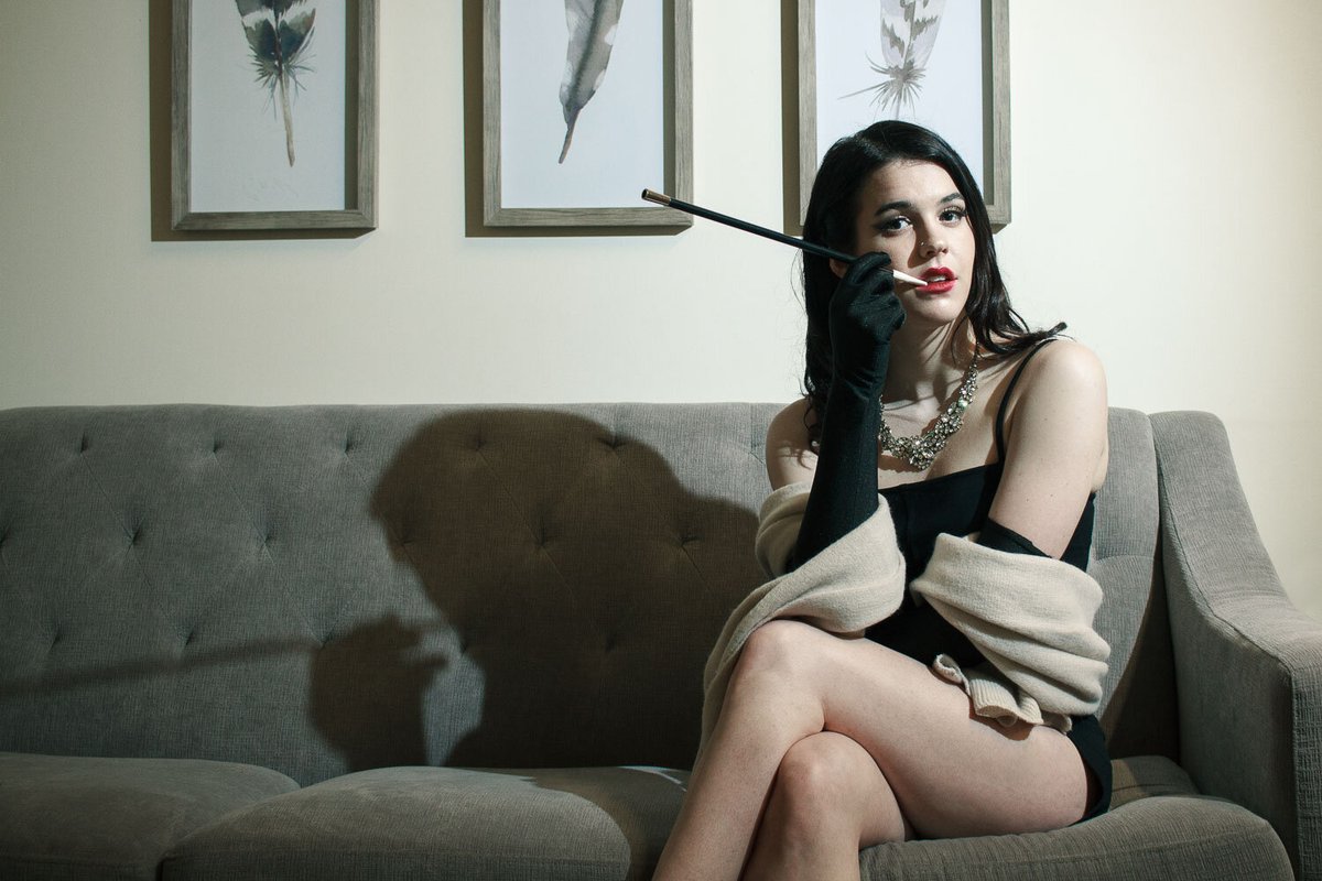 Old Hollywood portrait of a model sitting on a couch