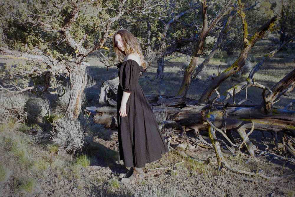 Romantic western aesthetic film photography portrait of a woman in a black dress