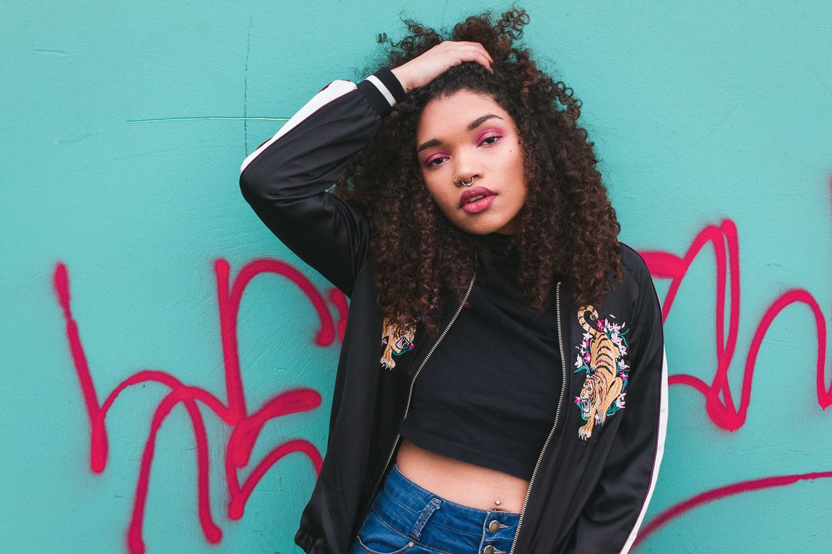 Model posing in front of graffiti in Portland, OR