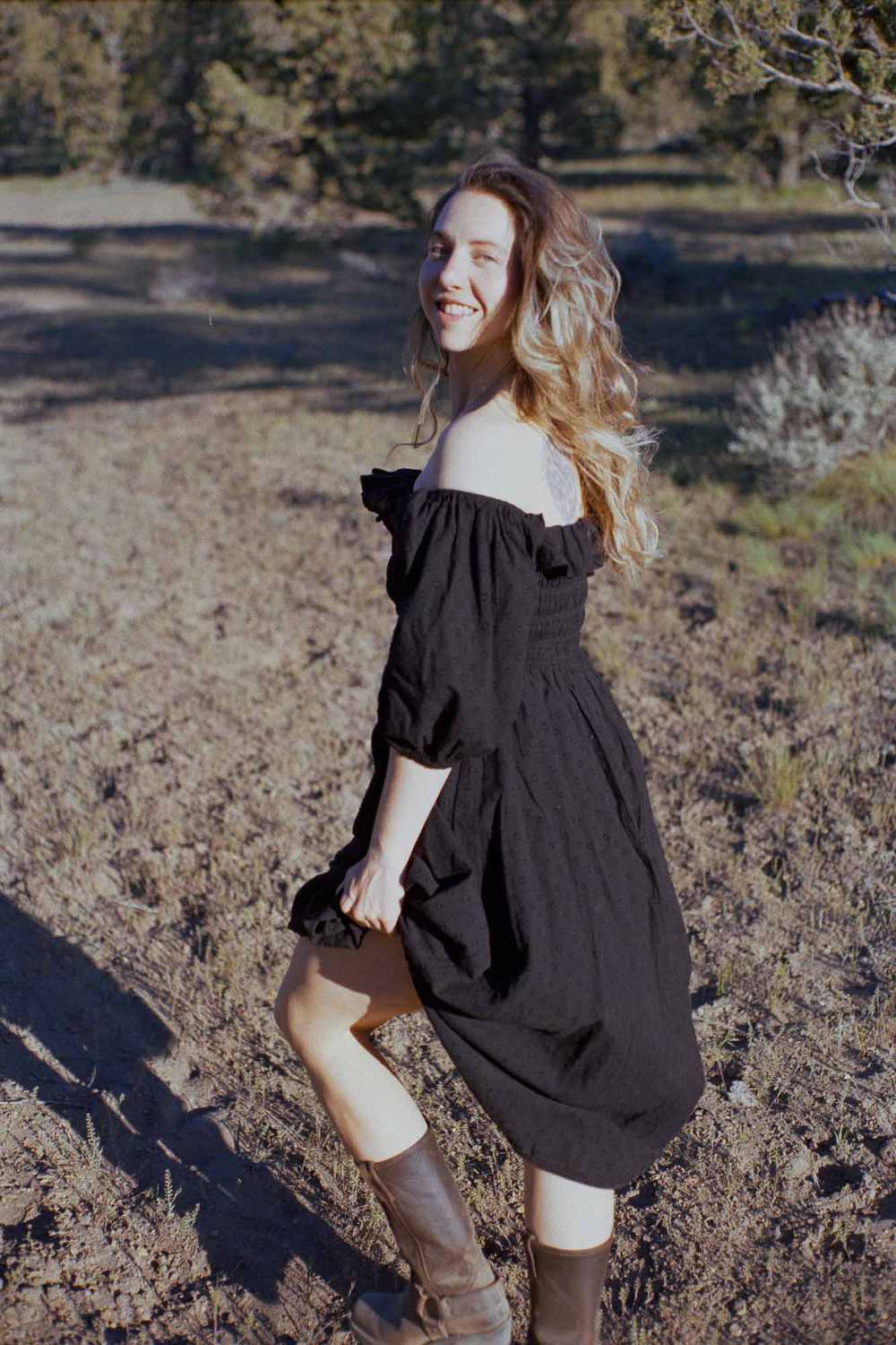 Romantic western aesthetic film photography portrait of a woman in a black dress